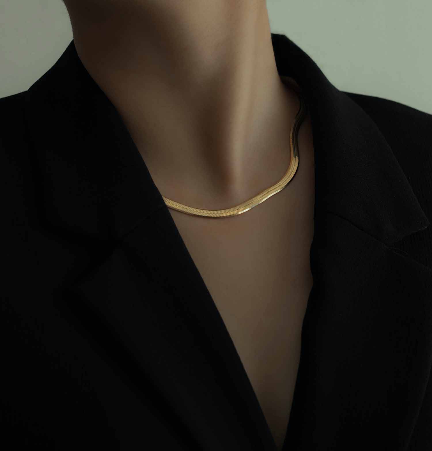 a person wearing a gold necklace